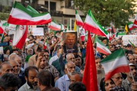 Iranian protesters chant slogans and one holds a poster with a vampire-like illustration of U.S. President Donald Trump in Tehran, Iran, on June 22, 2025.