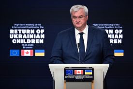 Ukrainian Foreign Minister Andrii Sybiha stands in front of a lectern with a microphone to attend a press conference of the International Coalition for the Return of Ukrainian Children.