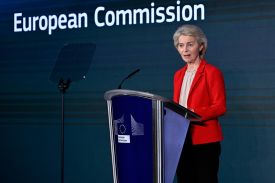 European Commission President Ursula von der Leyen speaks at a podium at the European Union headquarters in Brussels.