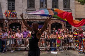 Crowds watch outside of Stonewall National Monument as people take part in the 2025 NYC Pride March in New York City.