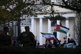 Anti-war demonstrators protest the war in Iran as members of the U.S. National Guard look on in Washington on April 7.