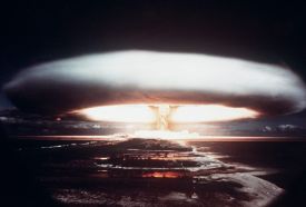 A vast mushroom cloud is seen from a far distance in this grainy photo.