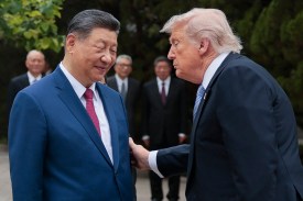 U.S. President Donald Trump, right, gestures to Chinese President Xi Jinping in Beijing.